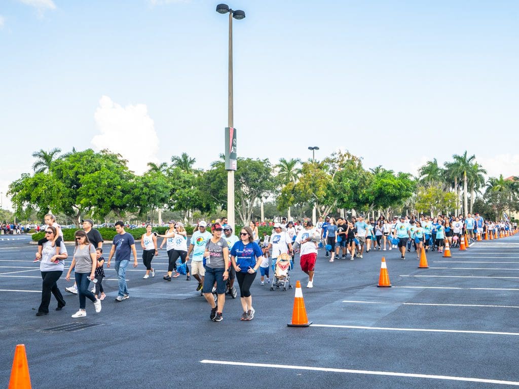 Petland Miami team walking in parking lot at Autism Speaks Walk.