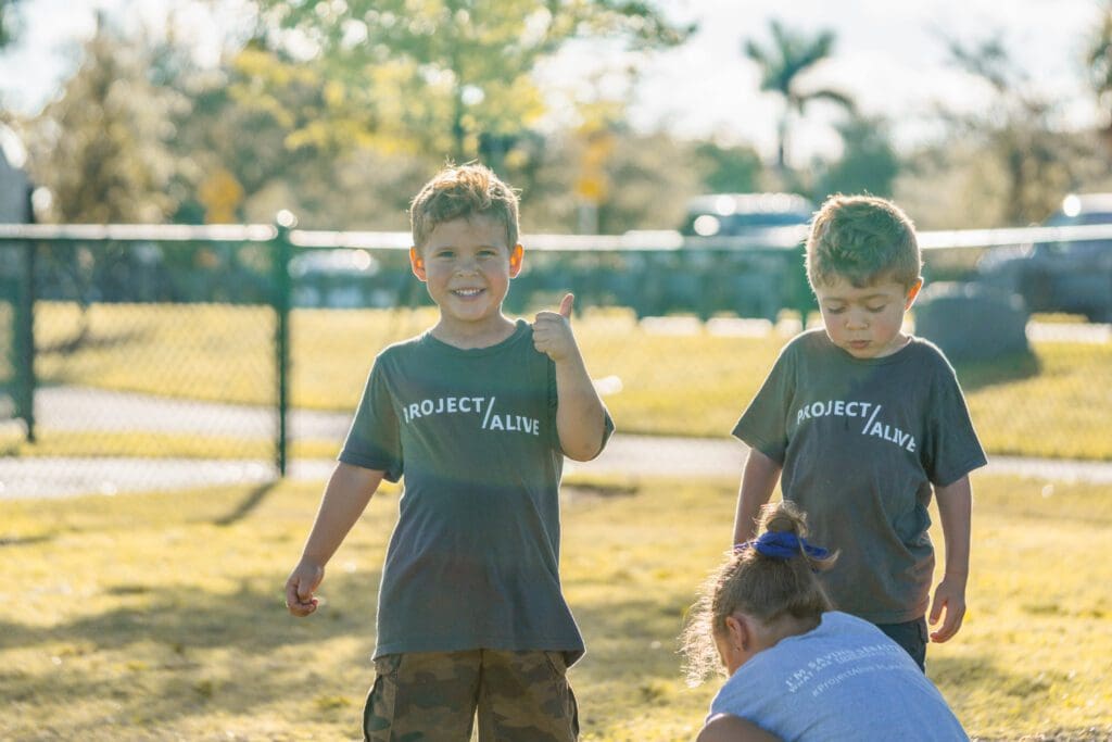Children having fun and looking at the camera while at Petland puppy playdate.